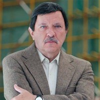 Neal Caine Man with dark hair and a salt-and-pepper mustache